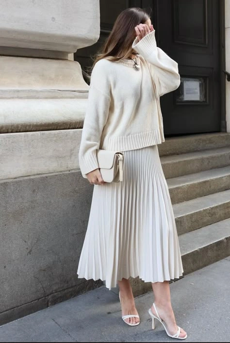 Ivory chunky knit sweater with pleated white midi skirt and white heels