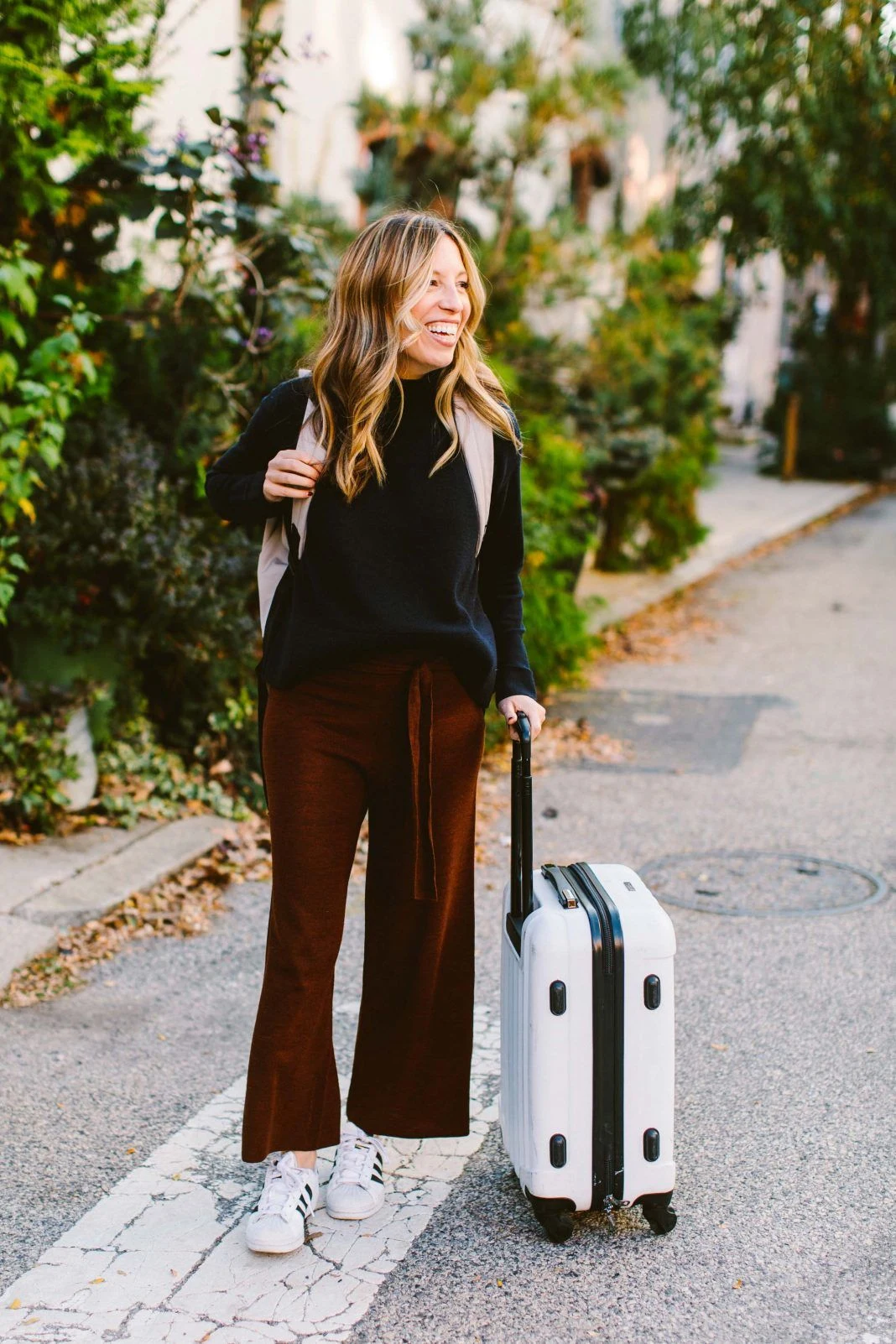 Black knit top with brown wide leg travel pants