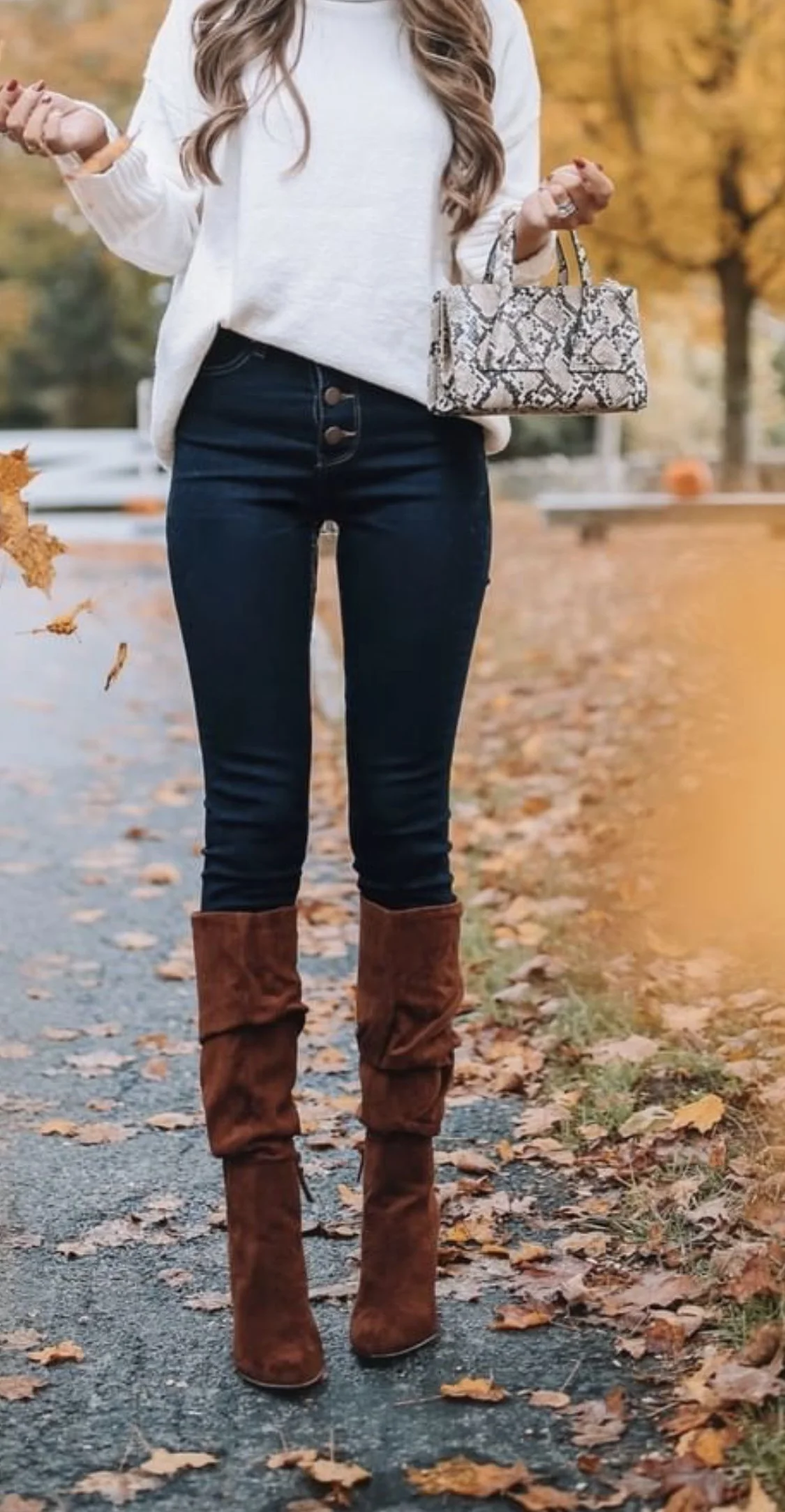 Thanksgiving outfit with white turtleneck, dark jeans, and brown suede knee boots