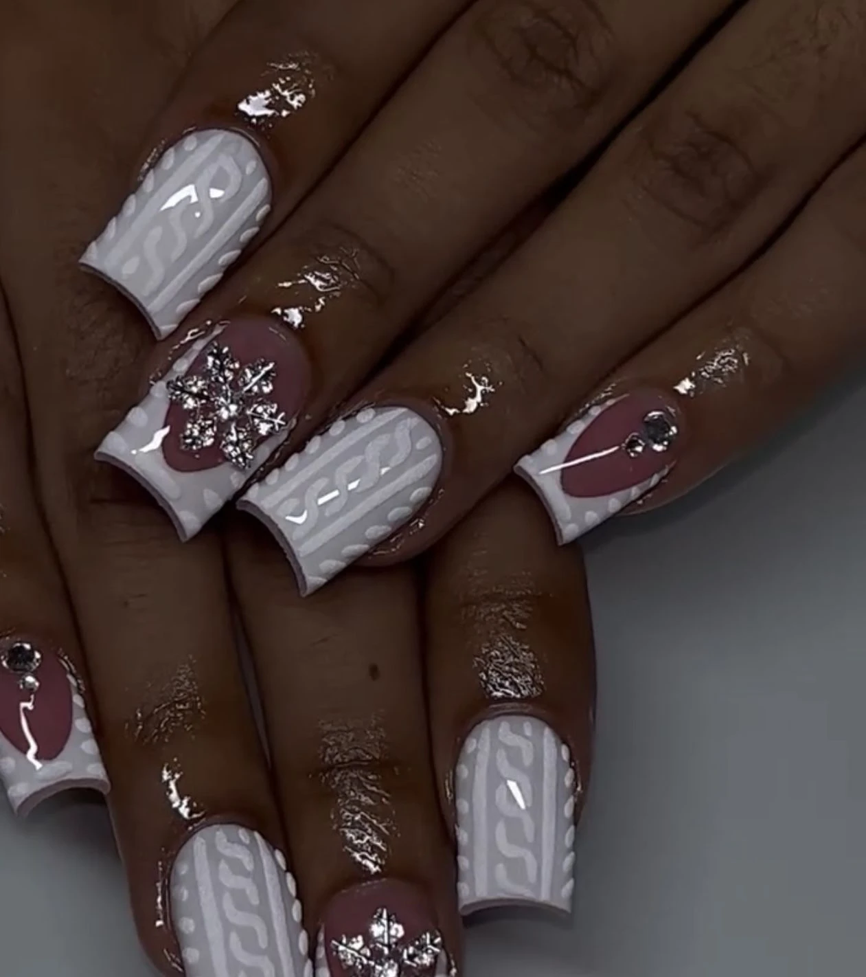 White knit nails with a crystal snowflake accent