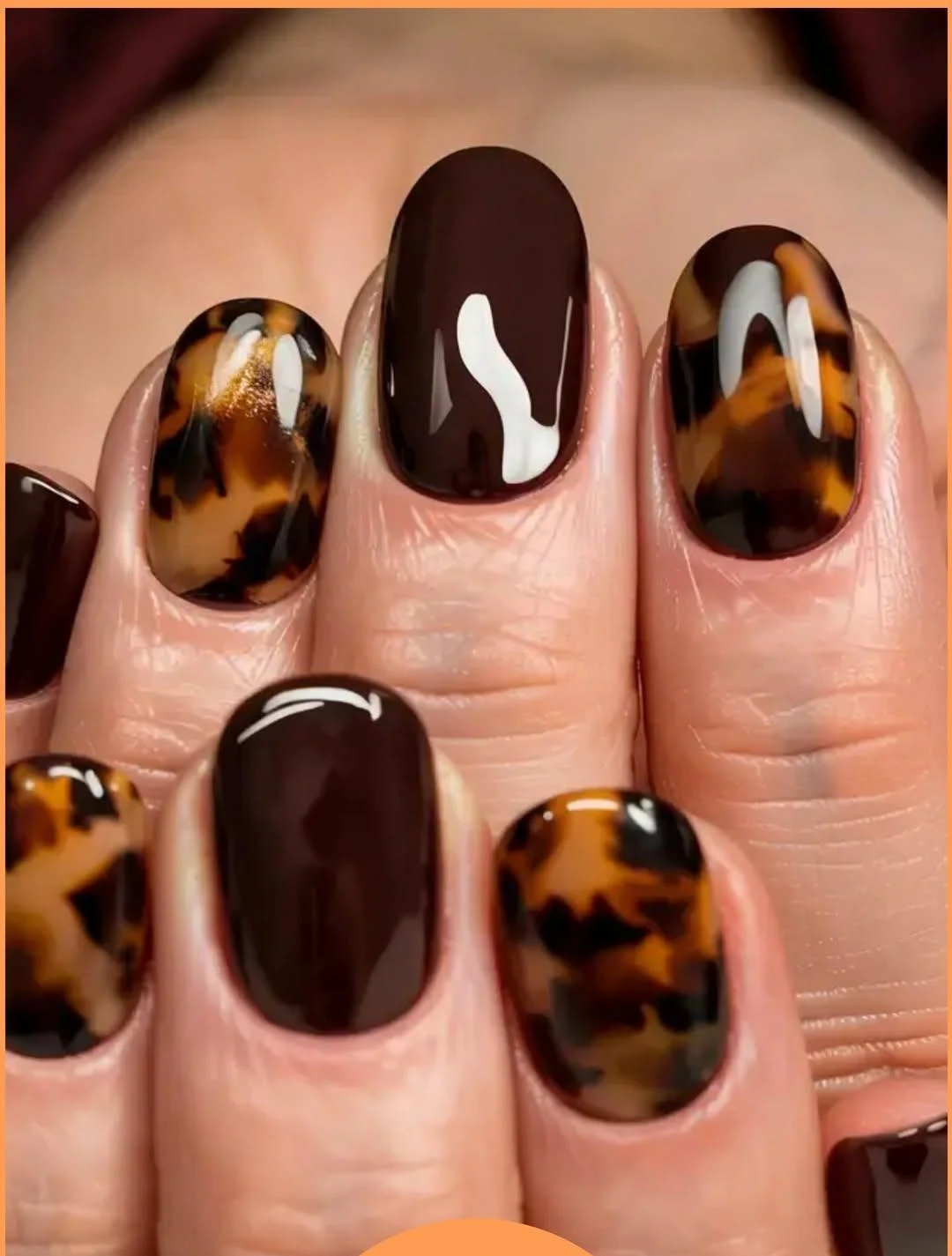 Tortoiseshell nails paired with dark chocolate solid nails
