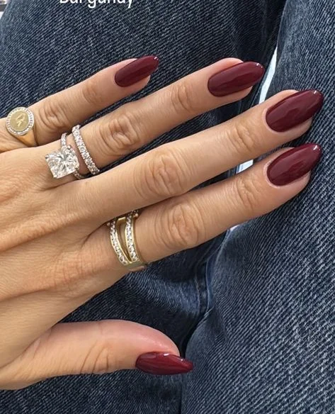 Deep red fall nails on pale skin