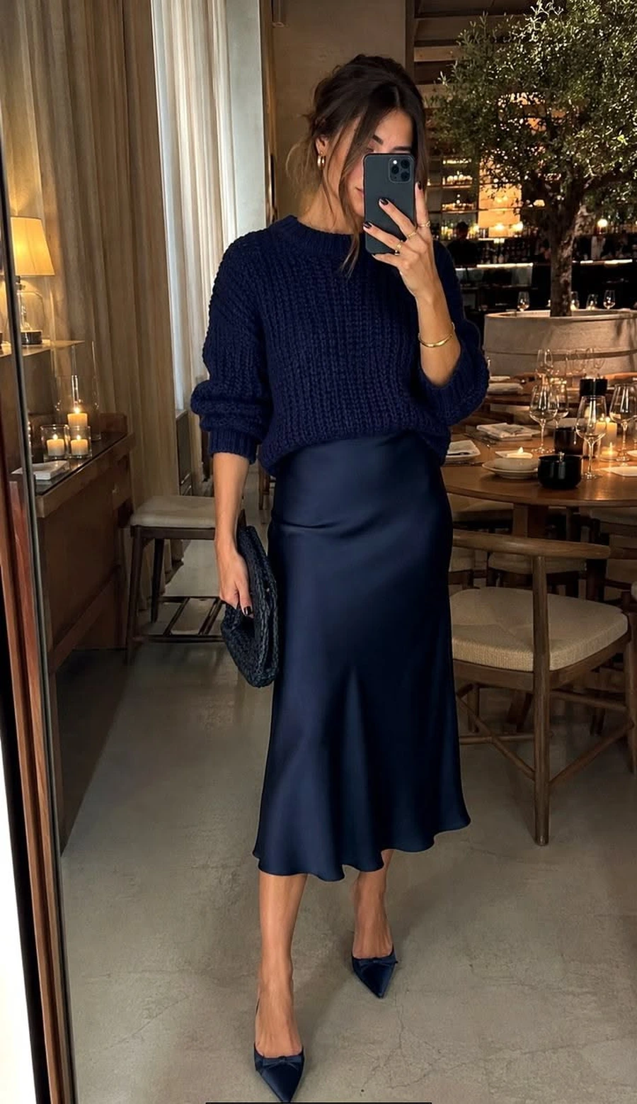 Woman in a soft sweater with a satin skirt and heels