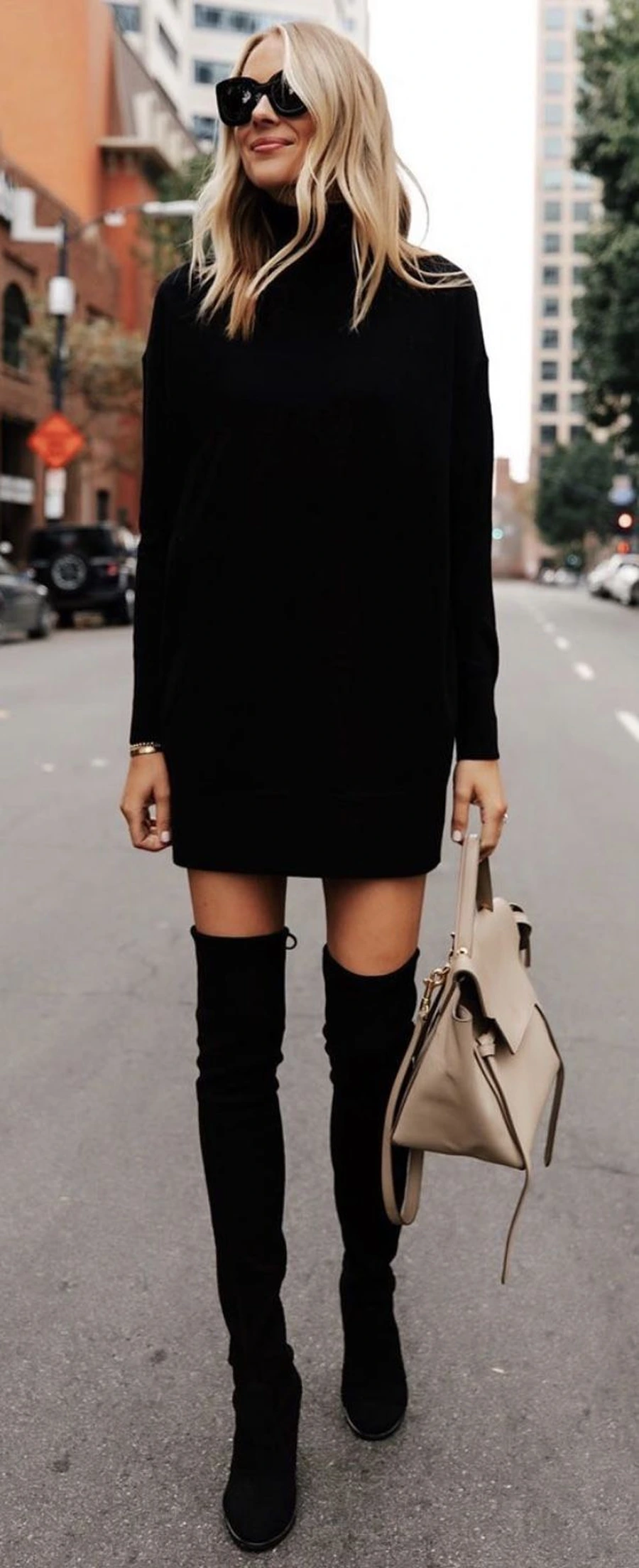 Woman in a turtleneck dress with over the knee boots