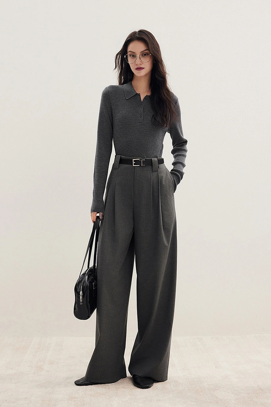Woman in a ribbed knit top with wool trousers and loafers