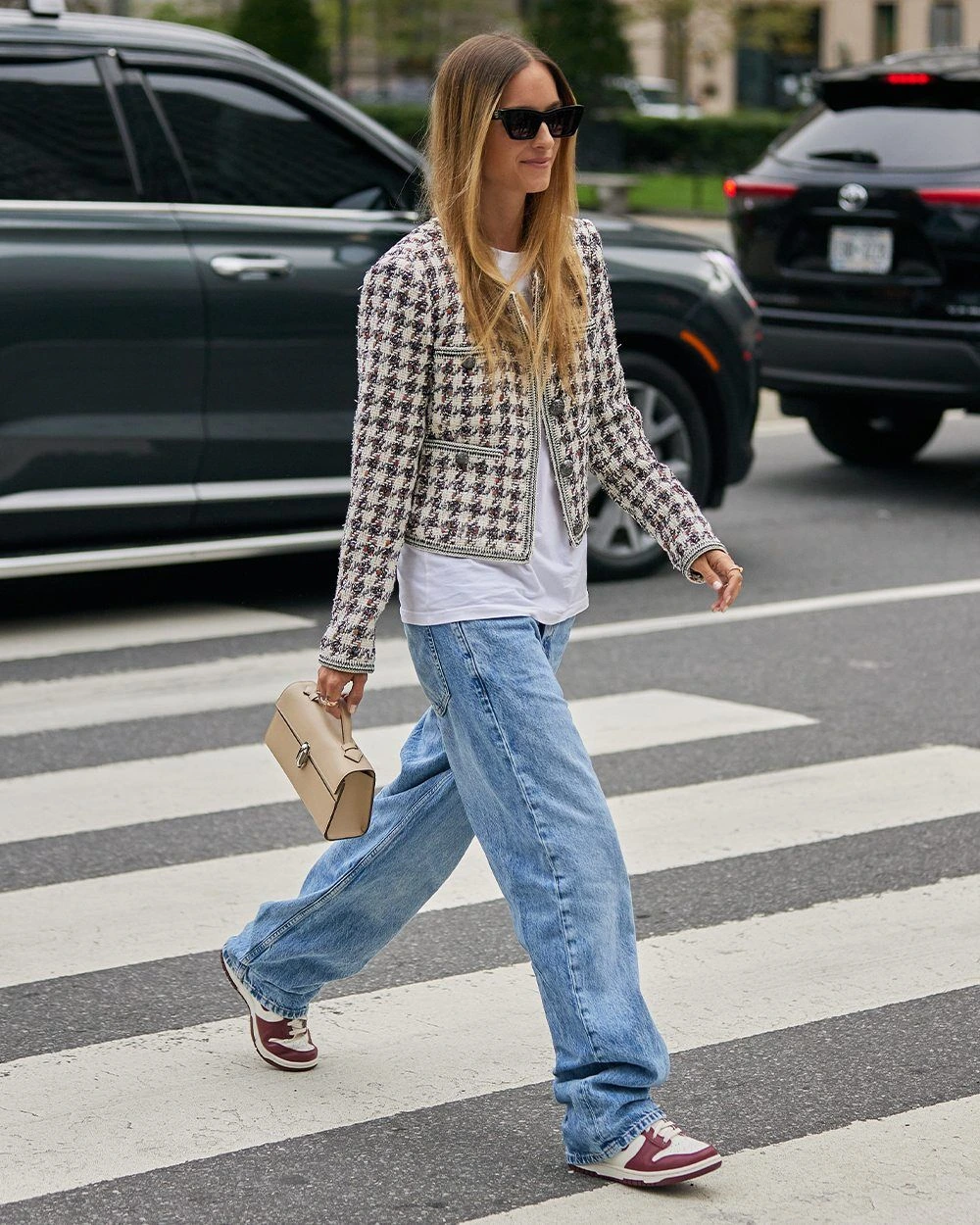 Woman in a tweed jacket with jeans and ballet flats