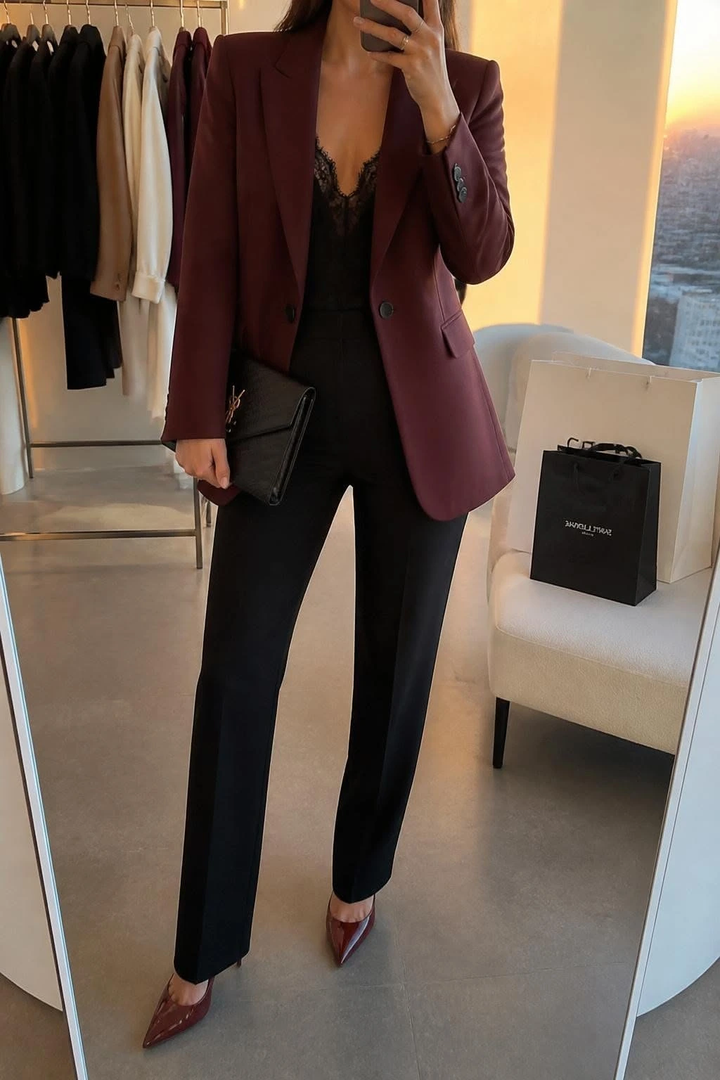 Woman wearing a burgundy blazer with a silk top and black trousers