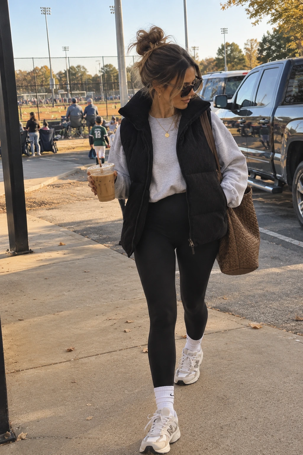 Woman wearing sporty sneakers with a puffer vest and leggings