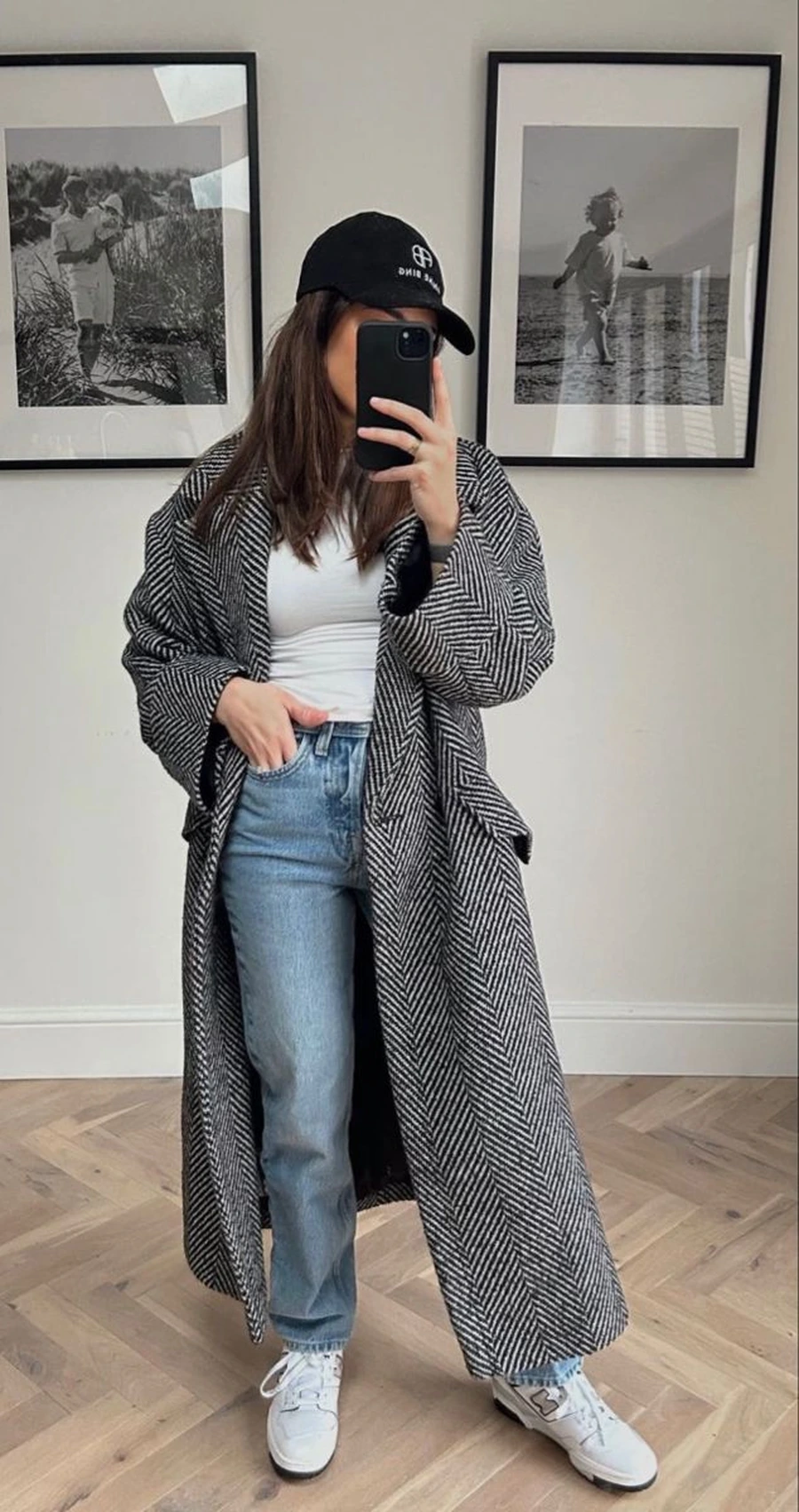 Woman wearing sneakers with a herringbone coat and ankle pants