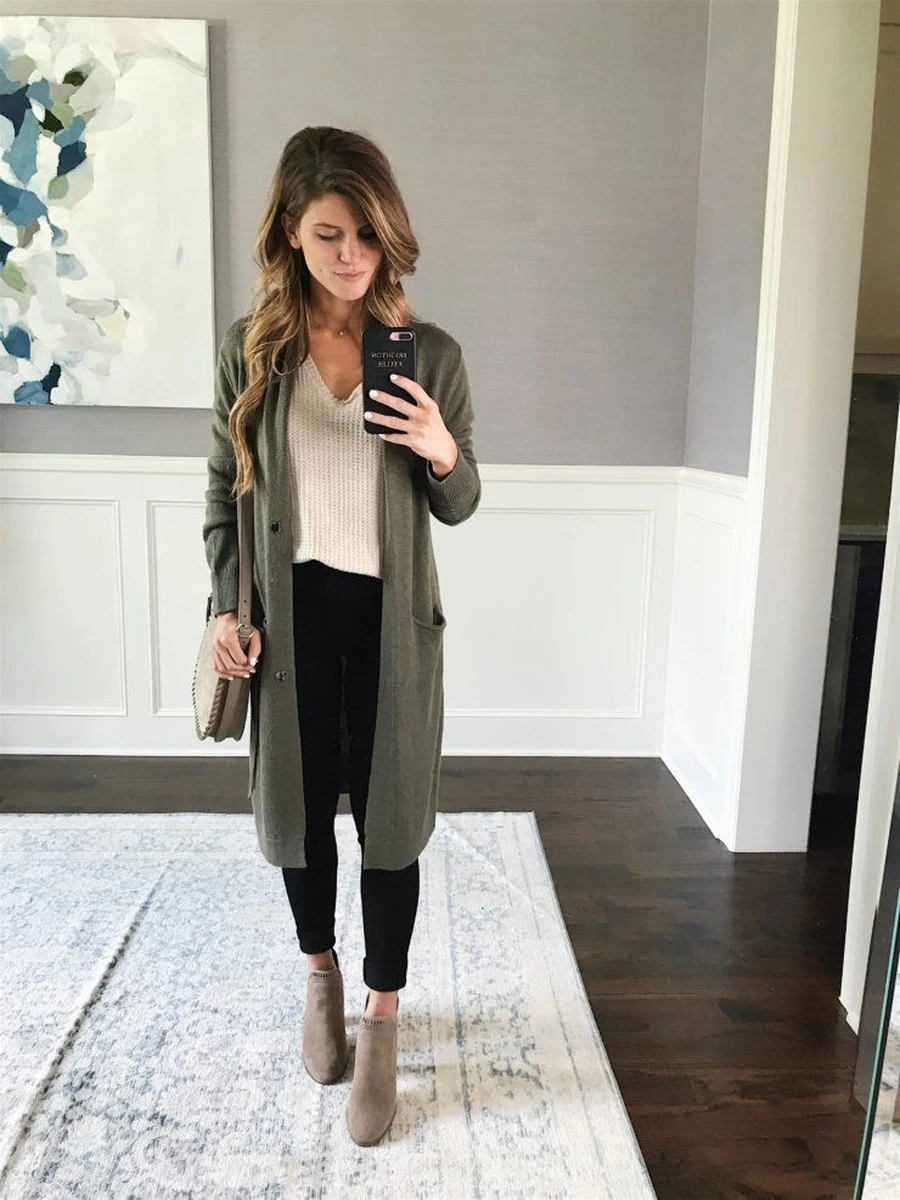 Tall woman wearing a long cardigan over slim trousers