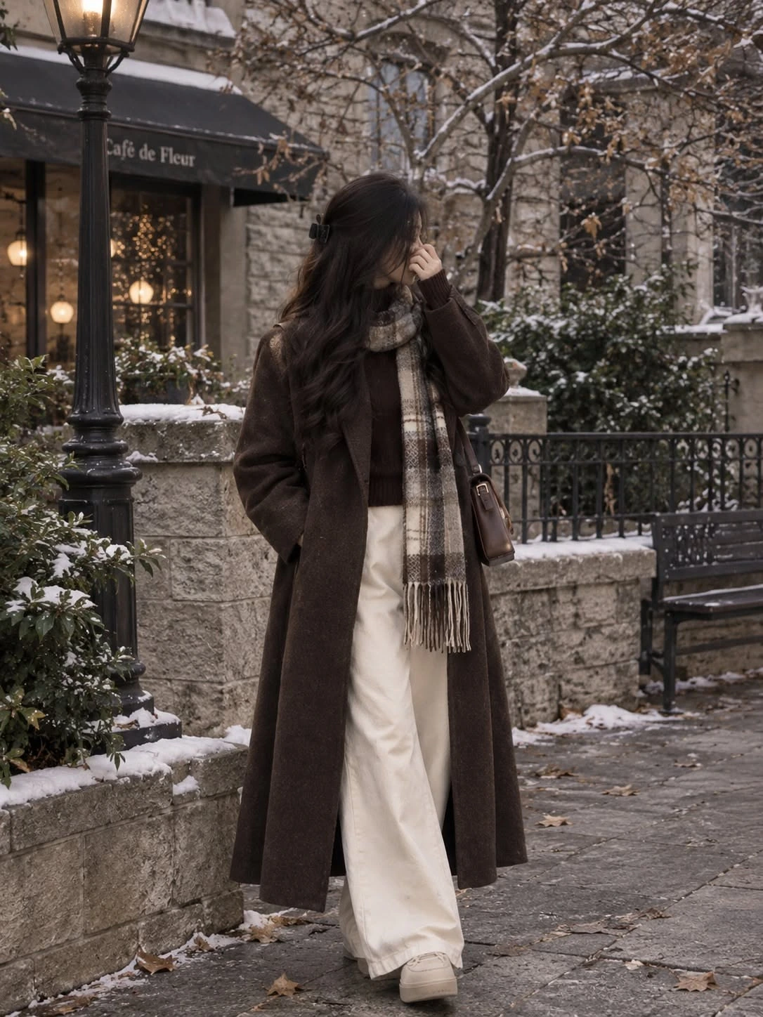 Tall woman wearing a long scarf layered over a coat