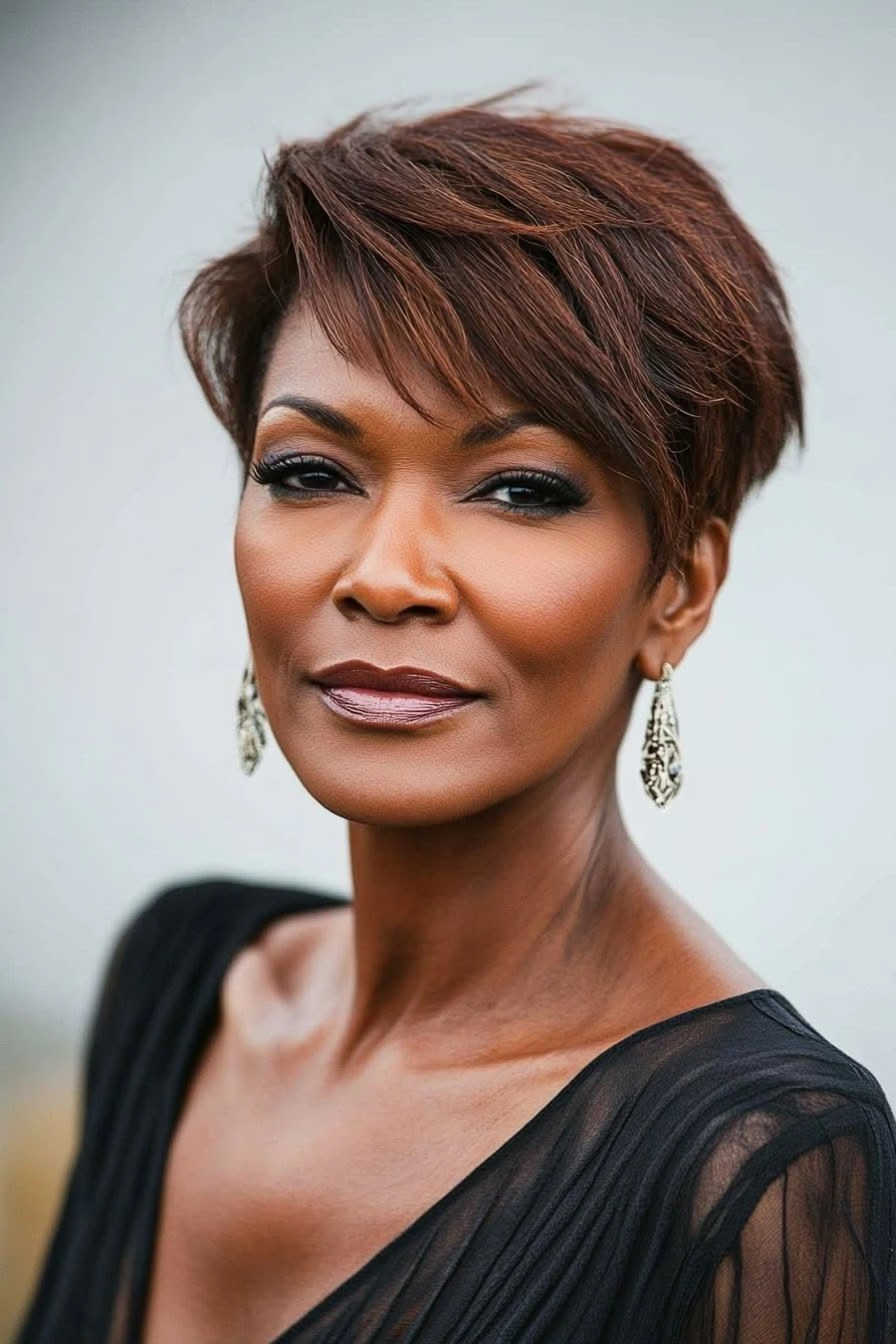 Woman over 50 with a classic pixie haircut and side swept bangs