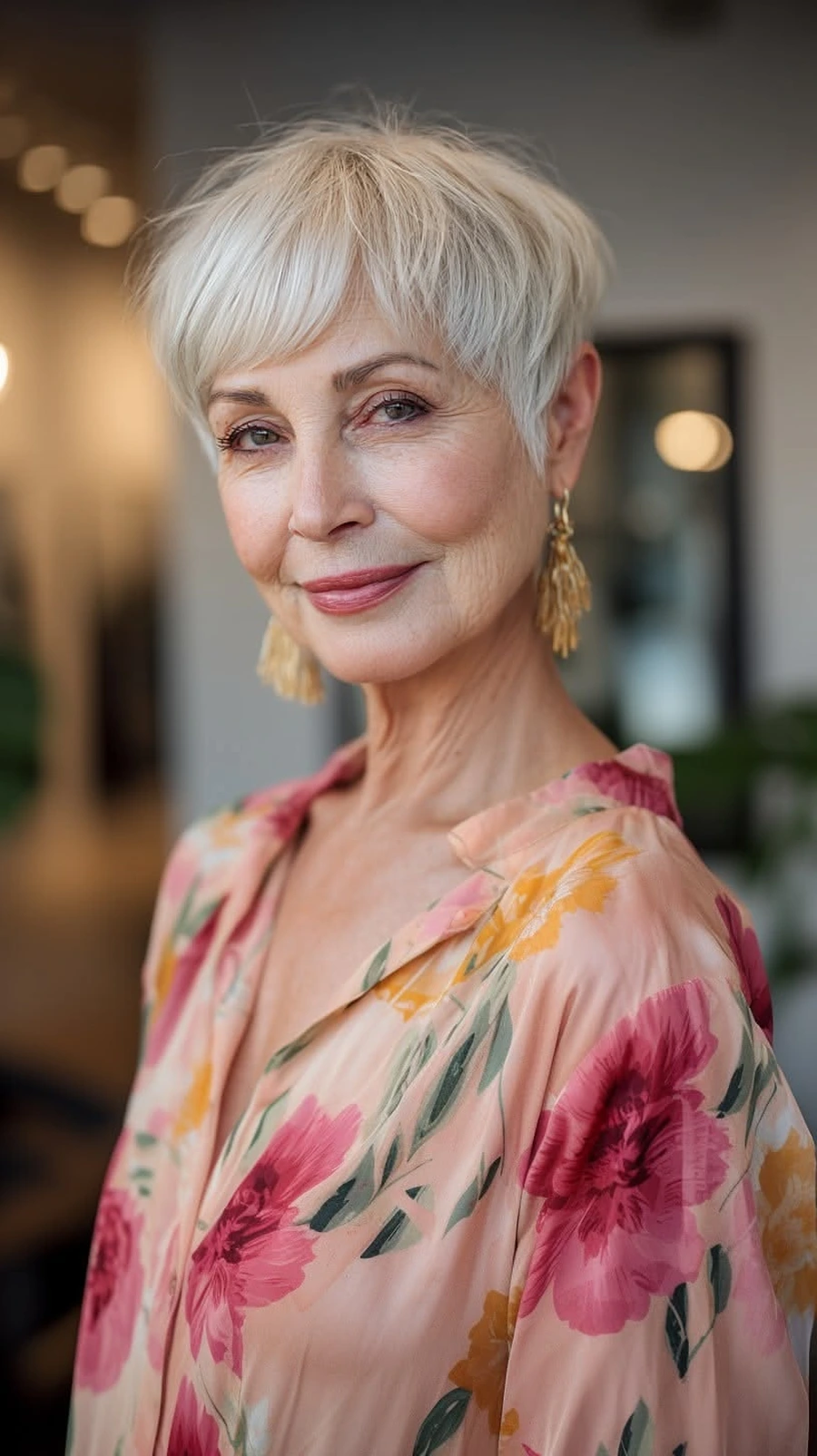 Woman over 50 with an edgy pixie and long sweeping bangs