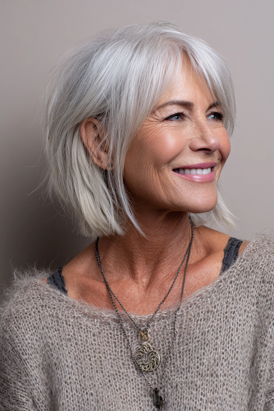 Woman over 50 with an elegant silver bob and soft bangs
