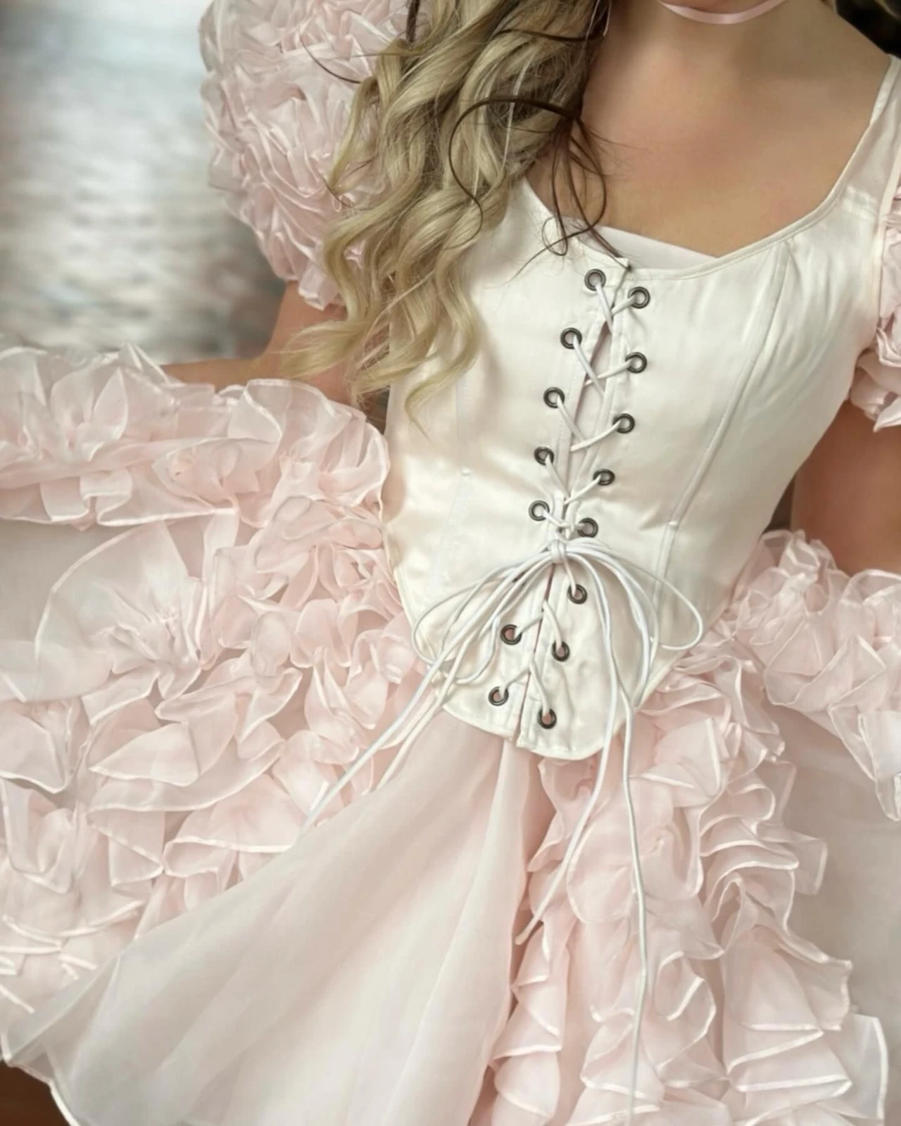 Lizzy McAlpine concert outfit: cream lace-up corset dress with ruffles
