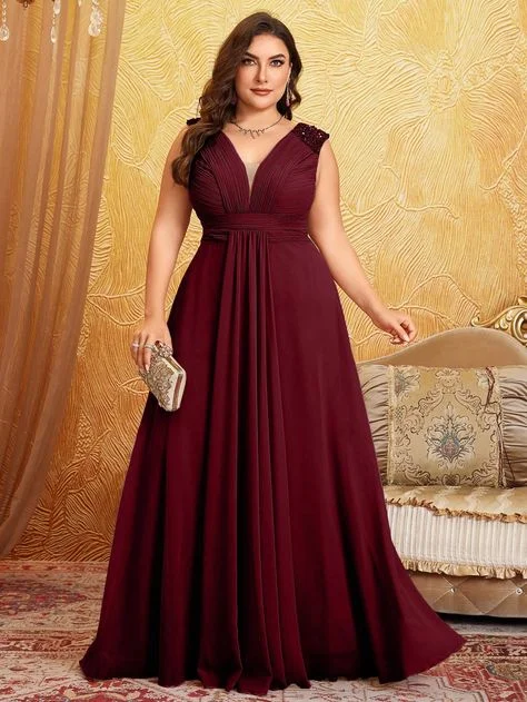 Burgundy sleeveless maxi gown on a plus-size woman