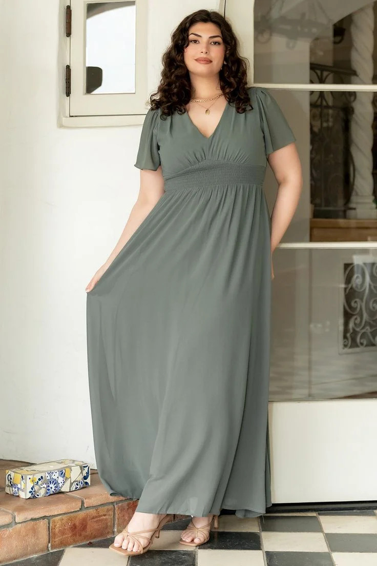 Gray empire waist long sleeve maxi dress on a curvy woman