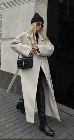 NYC fall outfit: white long coat with black beanie and boots