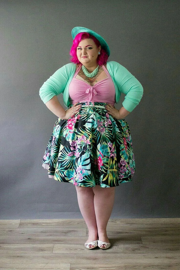 Mint cardigan over a tropical print skirt with pink hair and hat