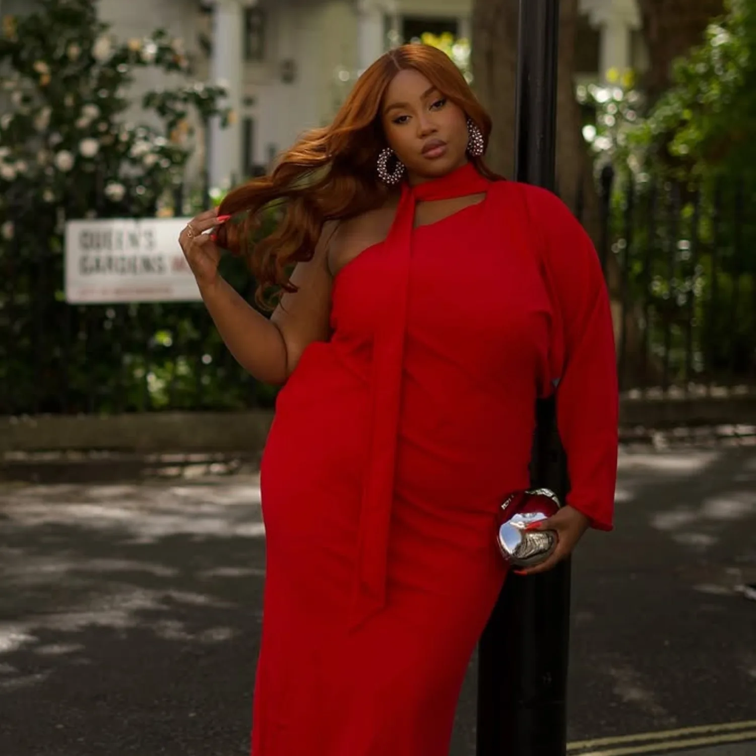 Red halter jumpsuit on a plus size woman