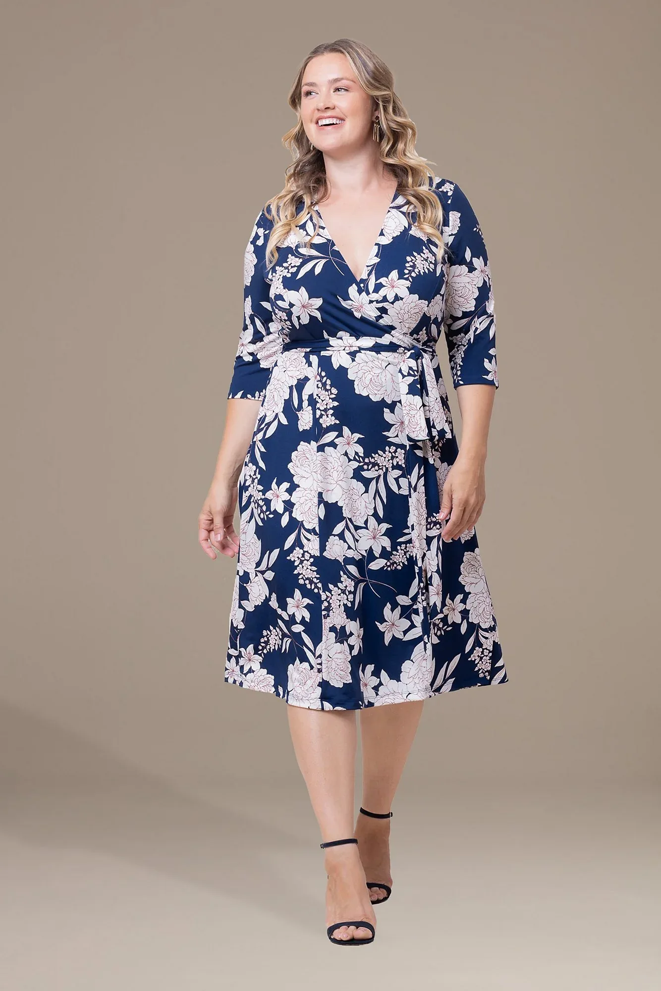 Blue floral wrap midi dress on a plus size woman
