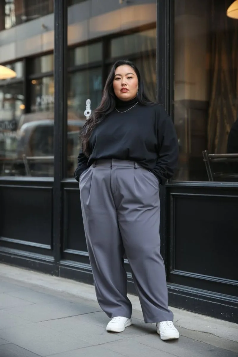 Plus size baddie outfit: black long-sleeve top with grey wide-leg trousers