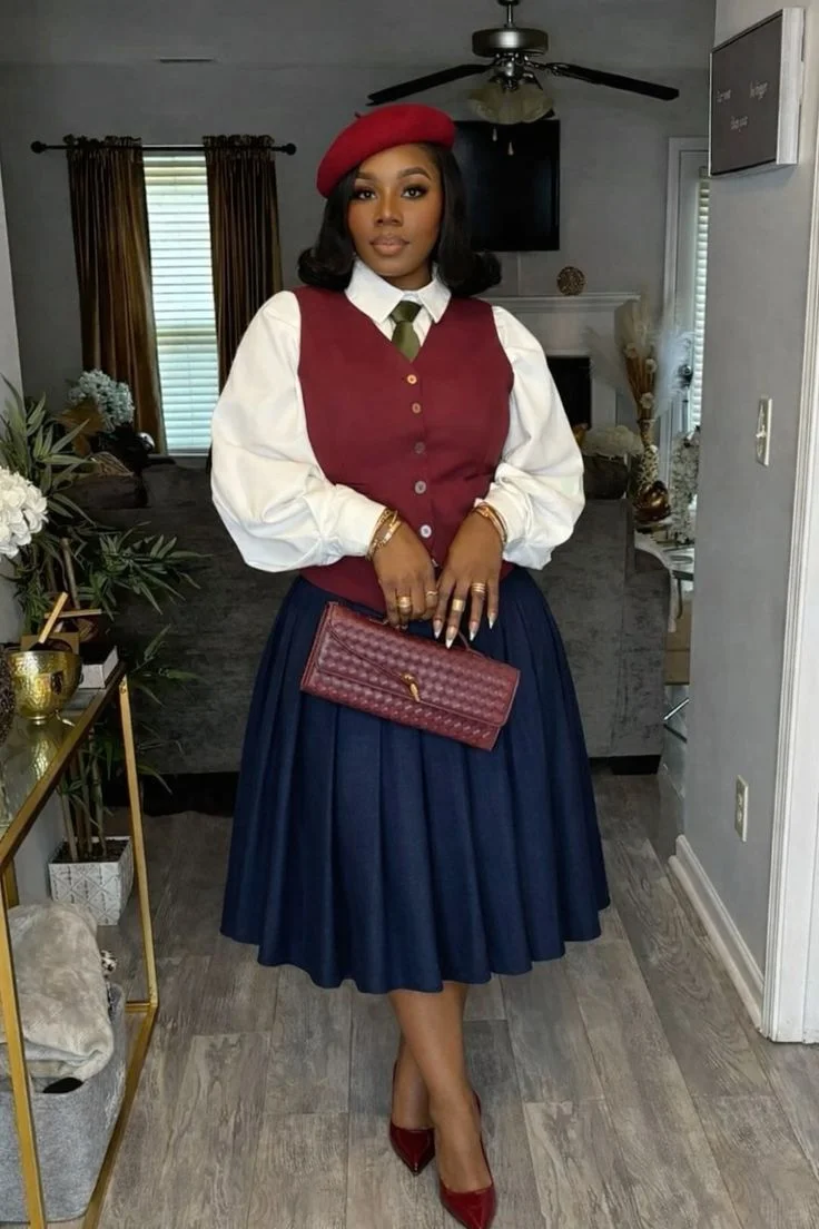 Plus size fall church outfit: burgundy vest with navy pleated skirt and beret