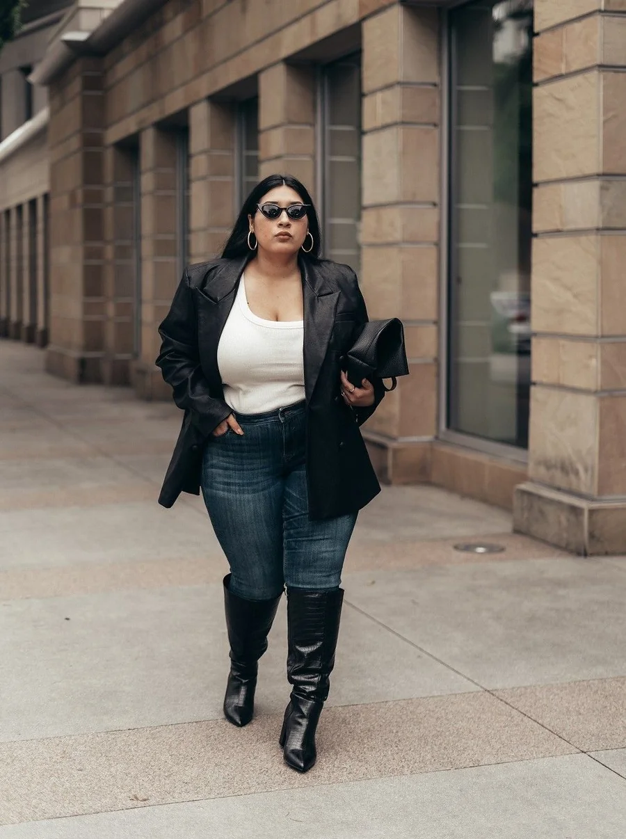 Plus size street style: black blazer, white tank, dark jeans and knee-high boots