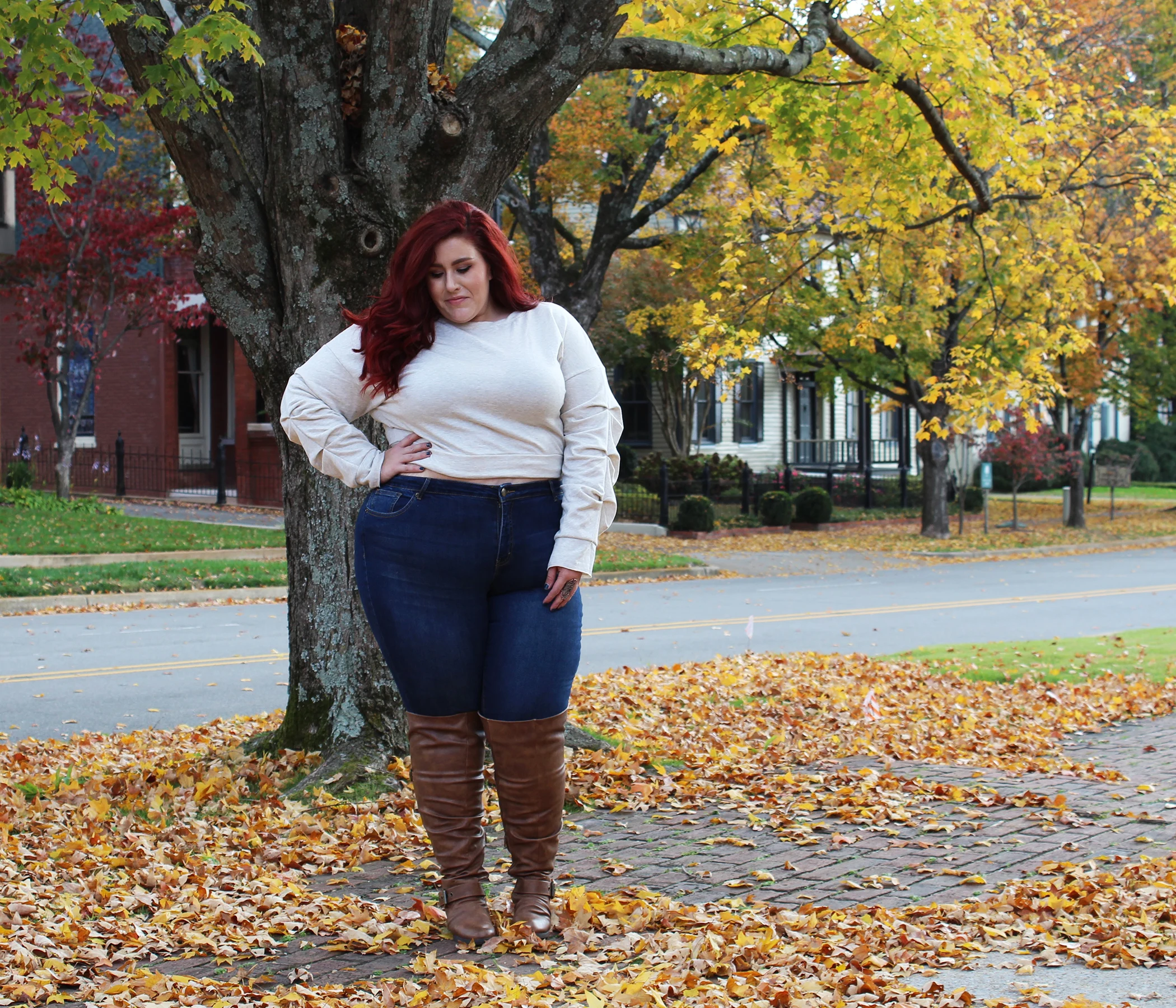Plus size fall outfit: cream sweater with dark jeans and brown boots