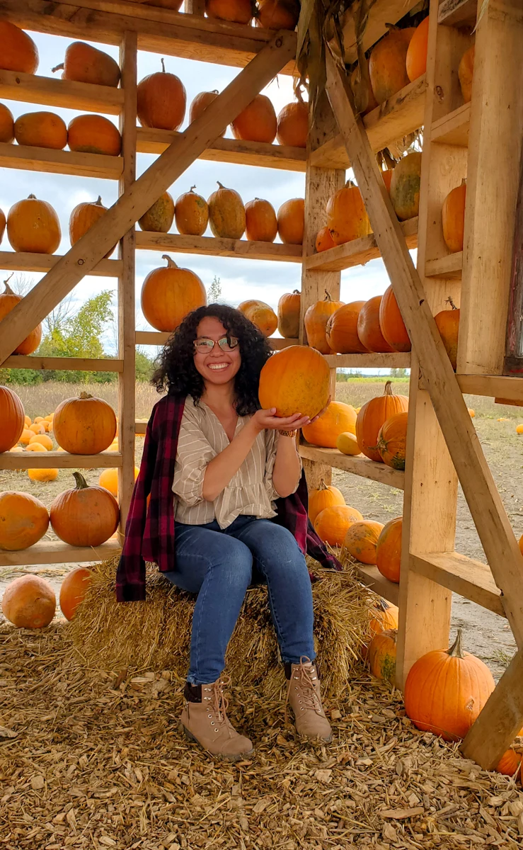 Plus size pumpkin patch outfit: striped blouse with plaid overshirt and jeans
