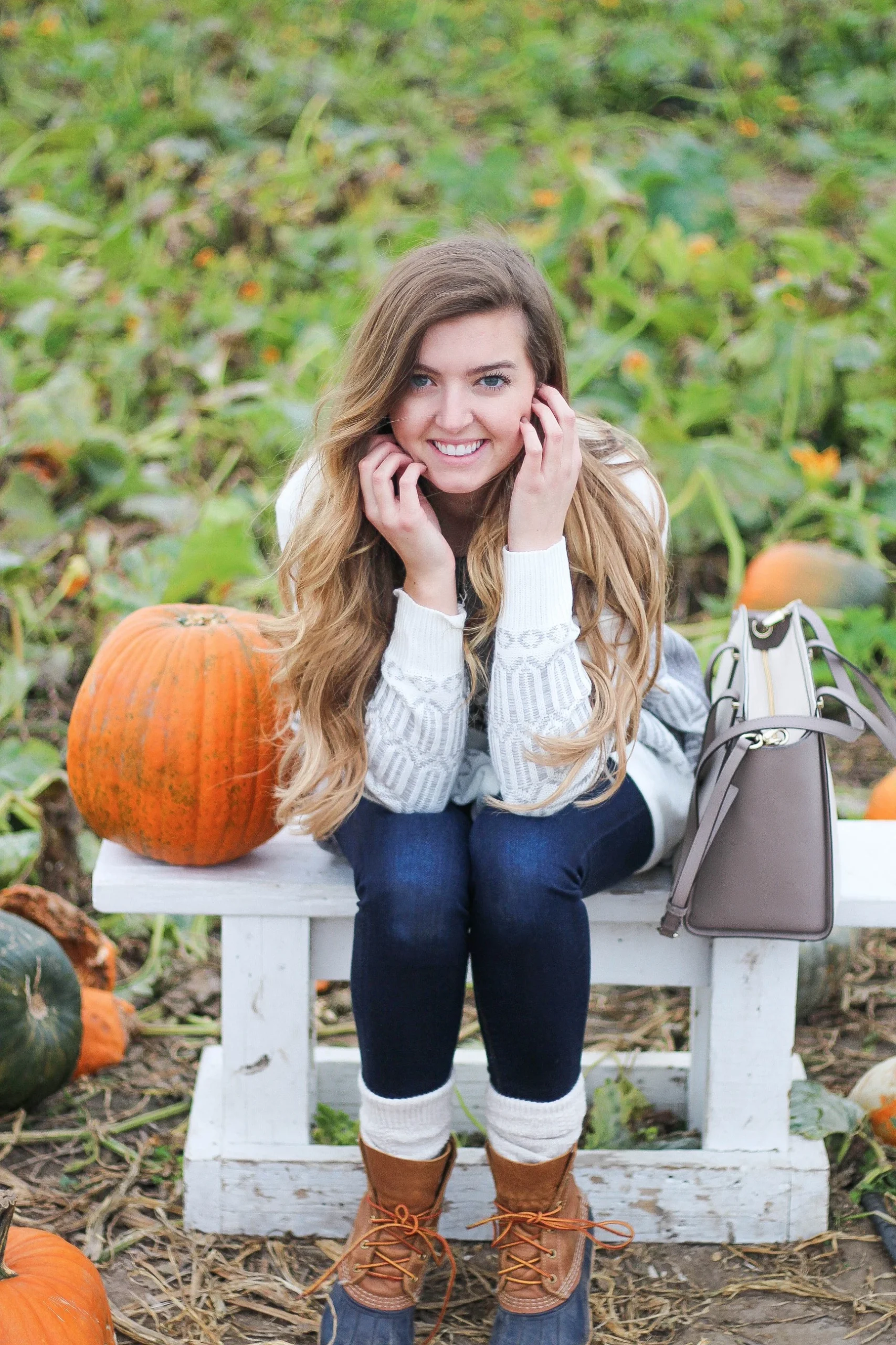 Plus size pumpkin patch outfit: white sweater with duck boots and tote