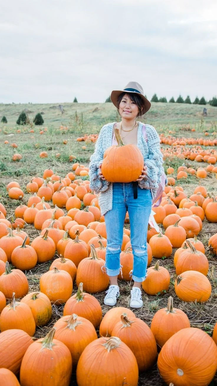 Plus size pumpkin patch outfit: chunky knit cardigan with ripped jeans and sneakers