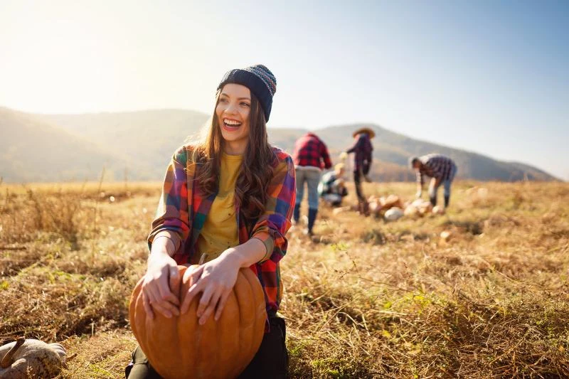 Plus size pumpkin patch outfit: plaid flannel shirt with yellow tee and beanie