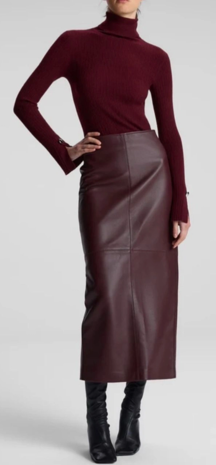 Petite woman wearing wine turtleneck with a burgundy leather skirt for Thanksgiving