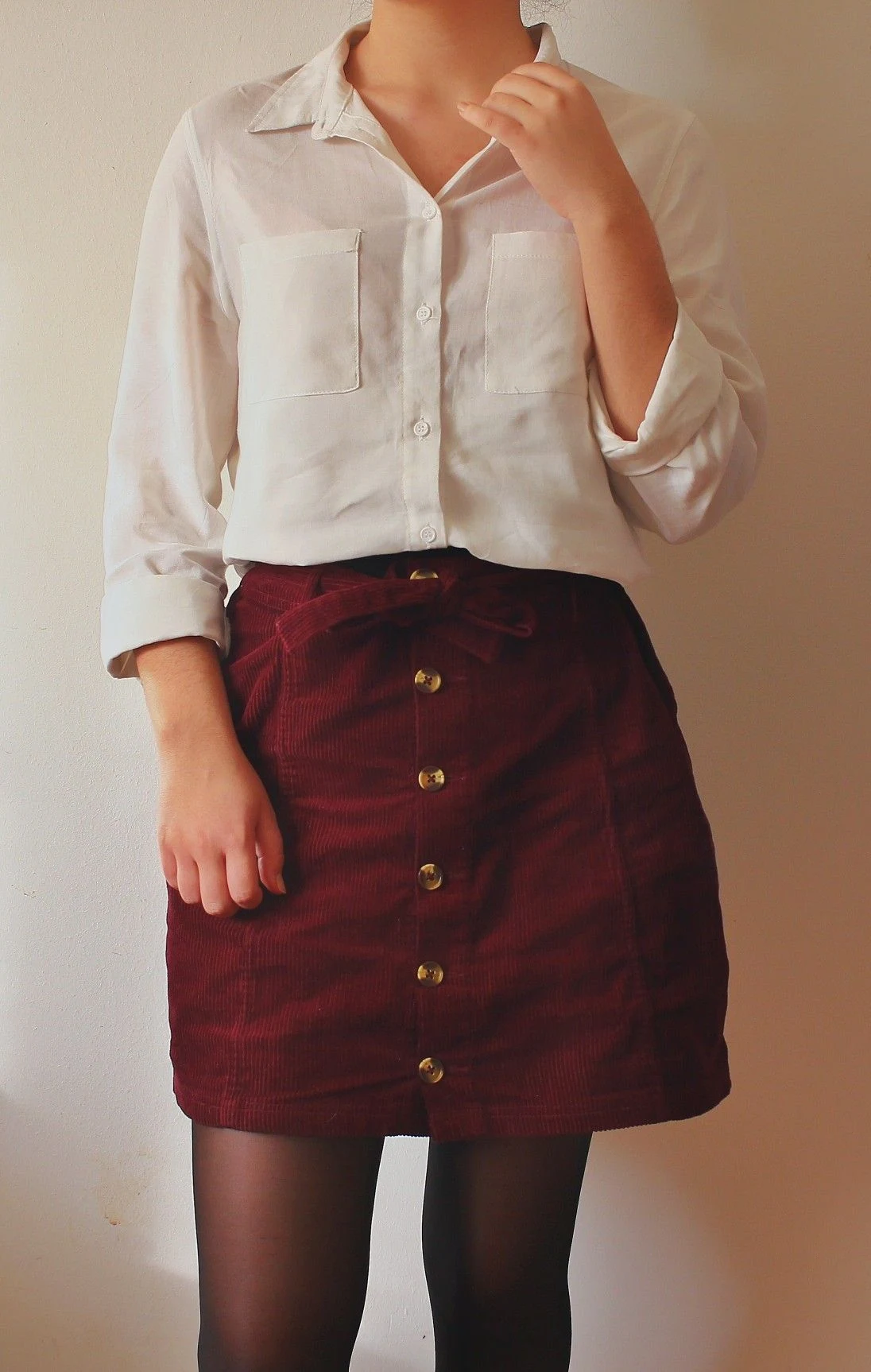 Petite woman wearing white blouse with a burgundy corduroy skirt for Thanksgiving