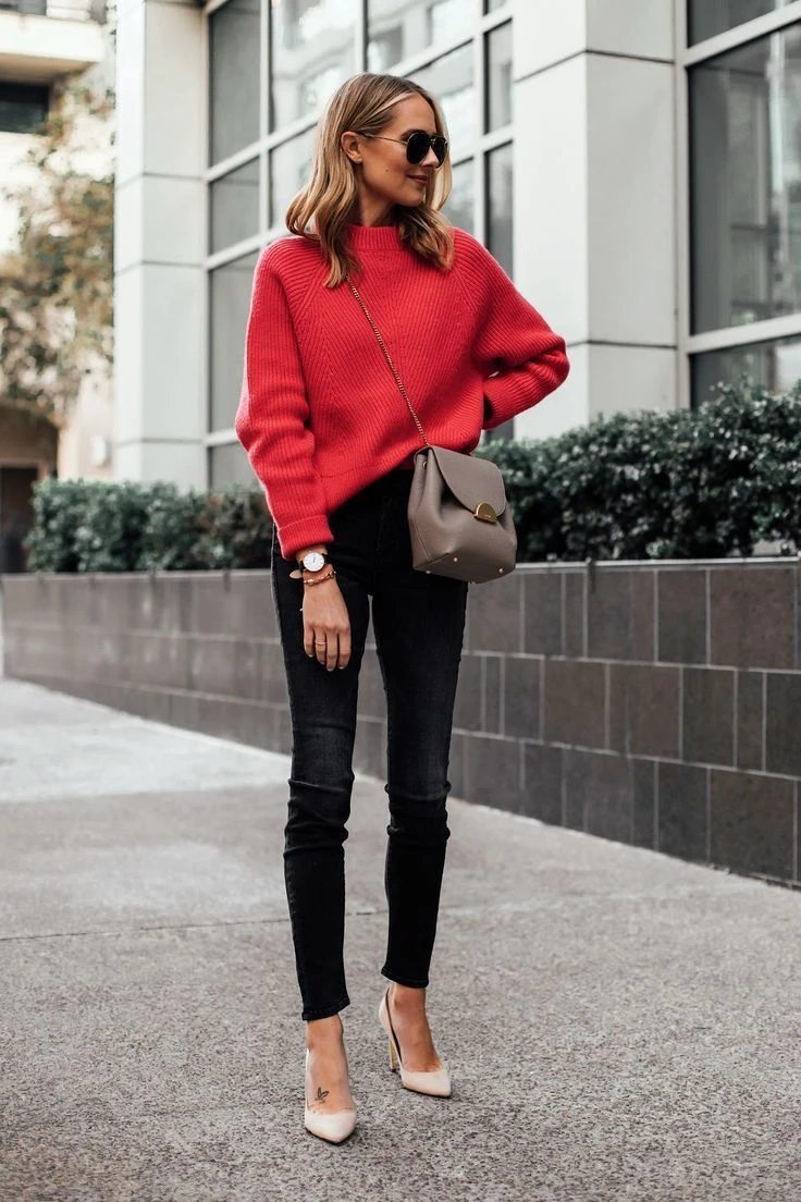 Petite woman wearing red sweater with black jeans and pointed heels for Thanksgiving