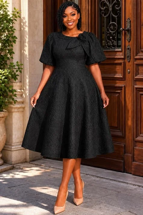 Thanksgiving dinner outfit: black fit and flare dress with flower shoulder detail