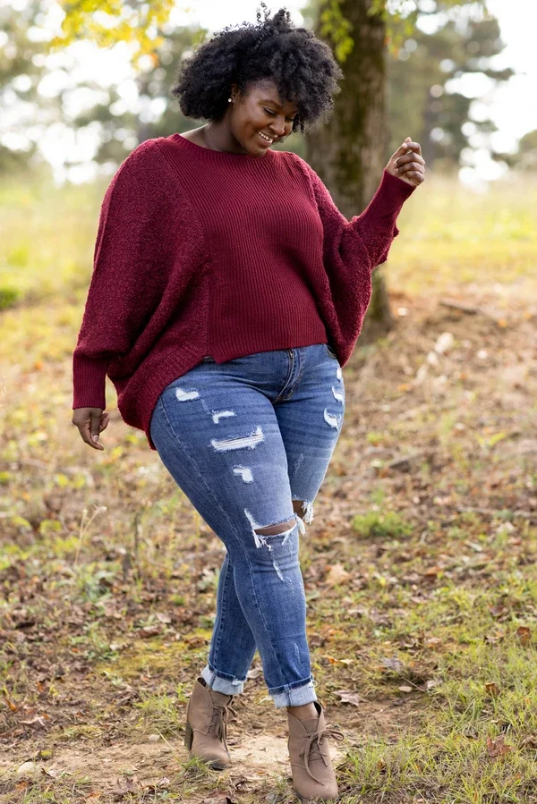 Casual thanksgiving outfit: burgundy sweater with distressed jeans and ankle boots
