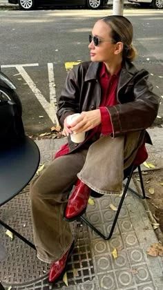 Brown leather jacket with wide-leg jeans and red ankle boots