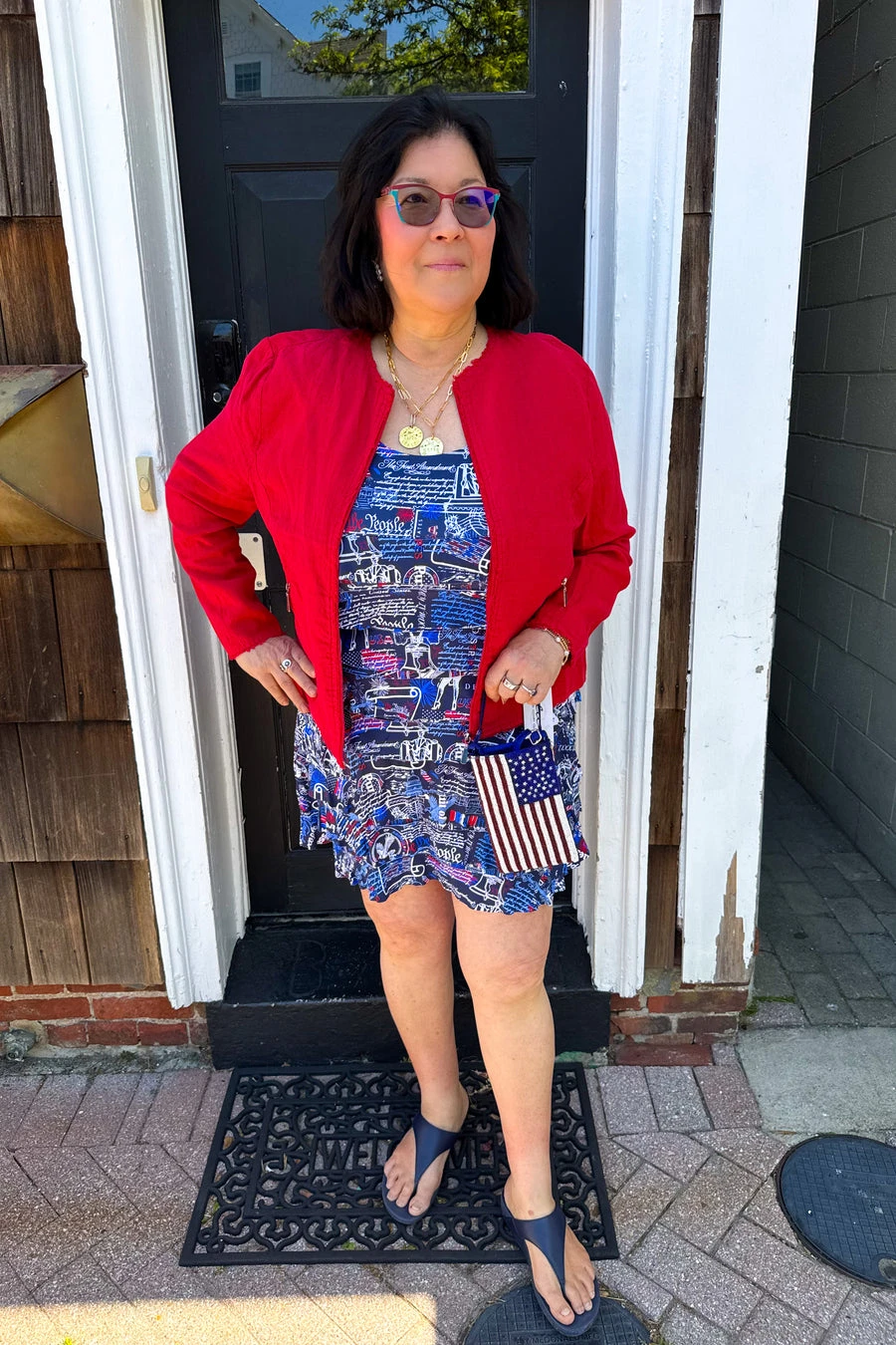 Veterans day outfit: red cardigan over flag print dress