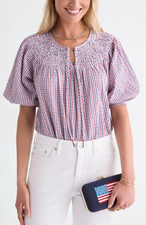 Veterans day outfit: gingham blouse with white pants and flag clutch
