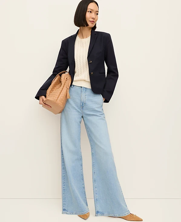 Veterans Day work outfit: Navy blazer with cream knit top and light wide leg jeans