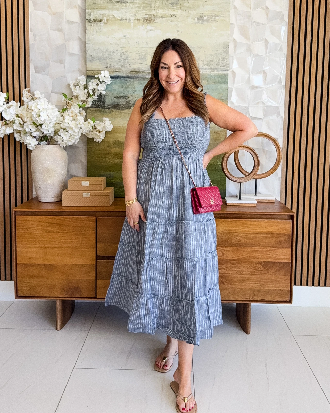 Veterans Day work outfit: Blue pinstripe midi dress with pink crossbody bag