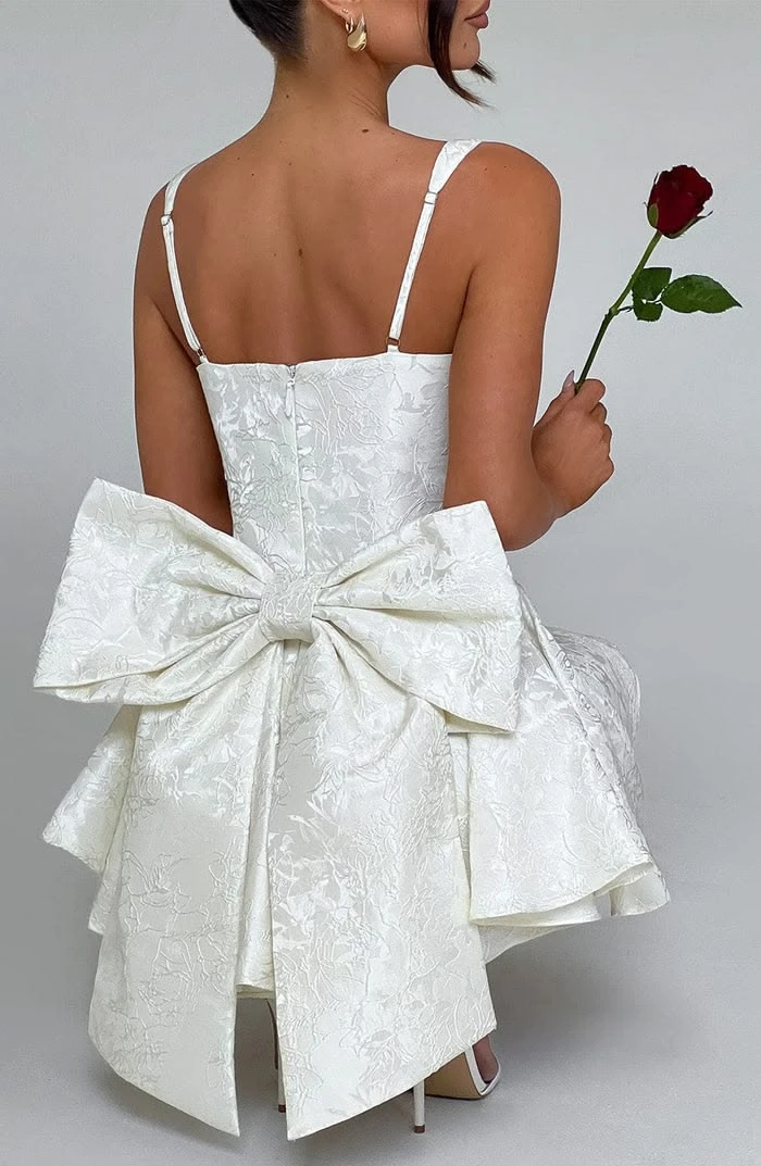 Whimsical outfit idea: white brocade mini dress with giant back bow