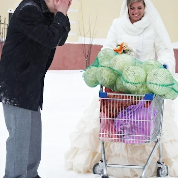 Bride pushing a shopping cart full of cabbages in the snow