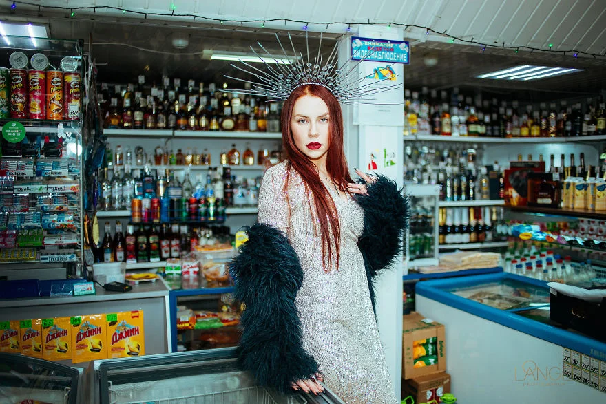Woman in a white gown with a black fur stole in a convenience store