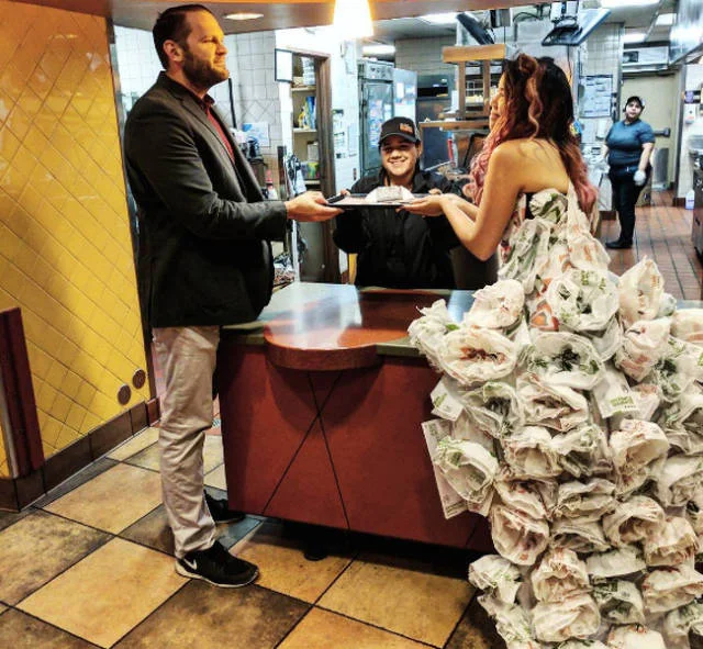 Woman in a money print dress at a fast food counter
